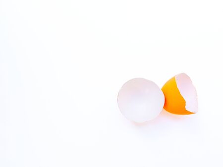 Broken yellow eggs on a white background close-up. High quality photo