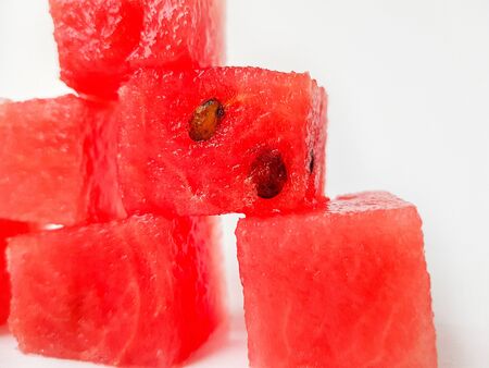 Bright ripe juicy red watermelon squares on a white background. Space for text. High quality photoの写真素材
