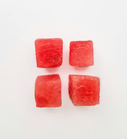 Bright ripe juicy red watermelon squares on a white background. Space for text. High quality photoの写真素材
