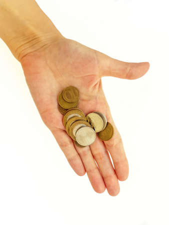 The womans hand holds Belarusian coins against a white background. High quality photoの写真素材