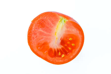 Ripe juicy tomato with drops of water on a white background. High quality photoの写真素材
