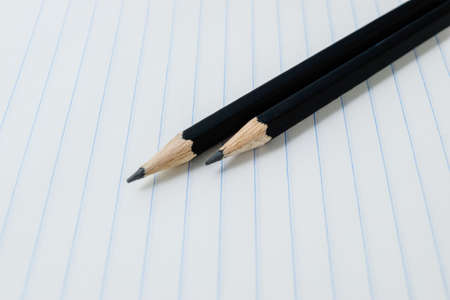 Griffin pencils on a white blank sheet notebook in the lineup. High quality photoの写真素材