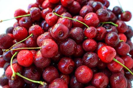 Red cherry ripe juicy on a white background. High quality photo