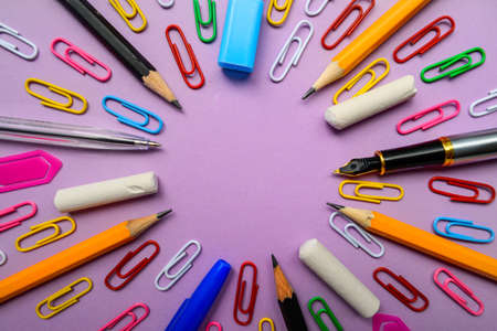 Stationery on a pink background form a circle. High quality photo