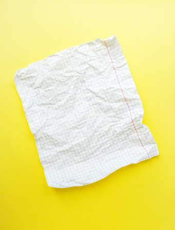 A white sheet of paper in a cage on a bright yellow background. High quality photoの写真素材