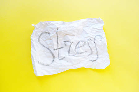The inscription is stress on a white sheet of paper in a cage on a bright yellow background. Step by step. High quality photoの写真素材