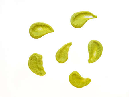 A drop of wasabi smeared on the surface on a white background is isolate. An artistic smear. High...
