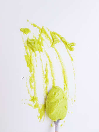 Spoon the wasabi on a stained surface on a white background. . High quality photoの写真素材
