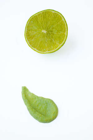 Green juicy sour lime and a drop of wasabi on a white background. High quality photoの写真素材