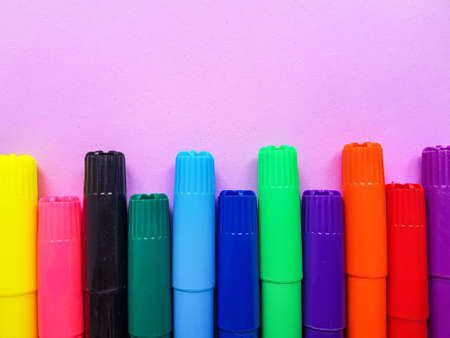 Multicolored markers on a purple background. Drawing. Back to school. . High quality photoの写真素材