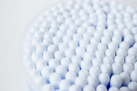 Cotton sticks ear blue plastic on a white background. Personal hygiene and care. Cosmetology and...