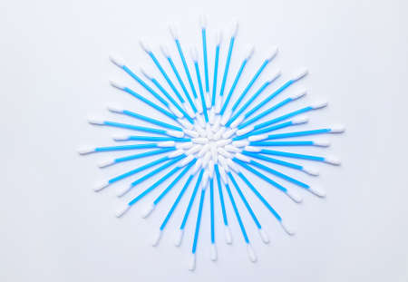 Cotton sticks ear blue plastic on a white background. Personal hygiene and care. Cosmetology and...