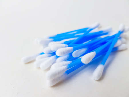 Cotton sticks ear blue plastic on a white background. Personal hygiene and care. Cosmetology and medicine. High quality photoの写真素材