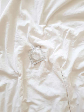 Condom on a white background. The concept of safe sex and protection from sexually transmitted infections. High quality photoの写真素材