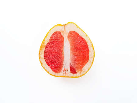 Red ripe juicy grapefruit in a cut on a white background view from above. The concept of diet and...