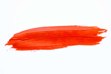 A smear of red paint on a white background. A place for text. . High quality photoの写真素材