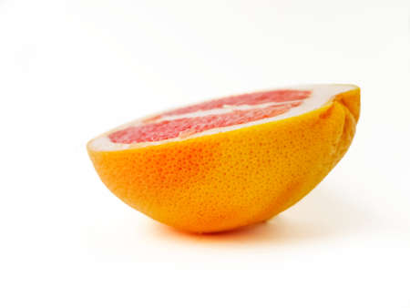 Red ripe juicy grapefruit in a cut on a white background. The concept of diet and healthy eating. A place for text. . High quality photoの写真素材