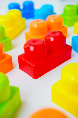 Scattered bright multi-colored childrens designer on a white background. Childhood. Useful and interesting games. High quality photoの写真素材