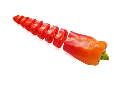 Red fresh pepper cut into equal parts of the ring on a white background. High quality photo