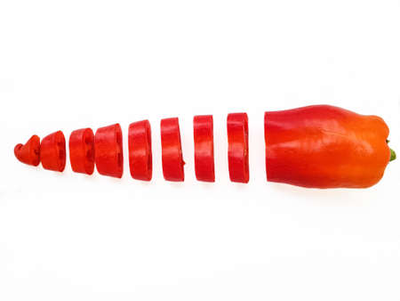 Red fresh pepper cut into equal parts of the ring on a white background. High quality photo