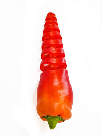Red fresh pepper cut into equal parts of the ring on a white background. High quality photo