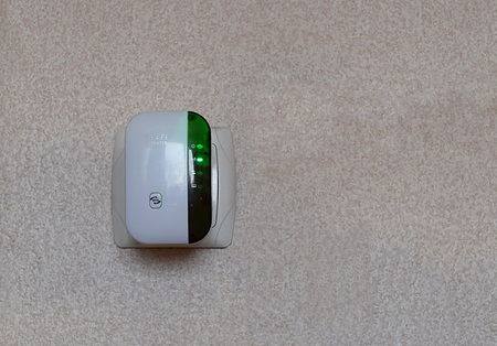 Repeater Wi-Fi signal in an electrical socket on the wall.