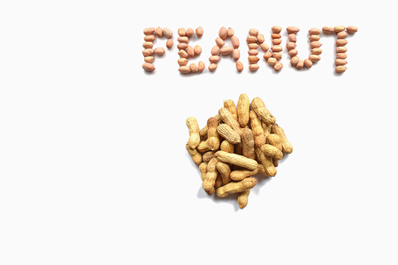 A bunch of unpeeled peanuts and the inscriptionの写真素材