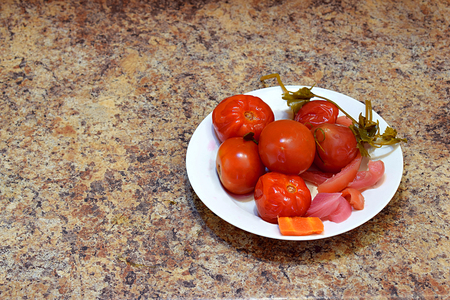 Marinated tomatoes with beets, carrots, apples and peppers, home cooking.の写真素材
