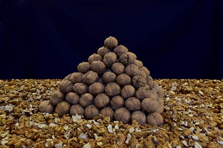 Walnuts folded in the shape of a triangular pyramid on the table.