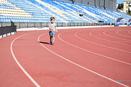 Little boy on the treadmill at the stadium. Education, healthy lifestyle.の写真素材