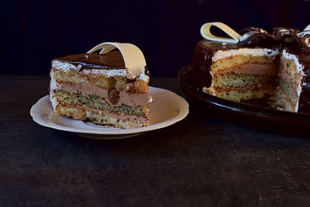Beautifully decorated chocolate coated cake, a slice of cake.の写真素材