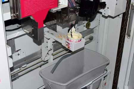 Ice cream vending machine in operation. view inside the machine.