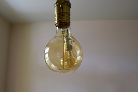 Vintage decorative incandescent lamp hanging from the ceiling close-up.