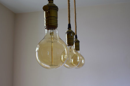 Vintage decorative incandescent lamp hanging from the ceiling close-up.の写真素材