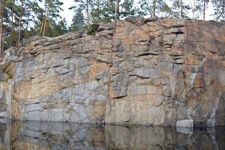 Vertical wall of an old granite quarry.の写真素材