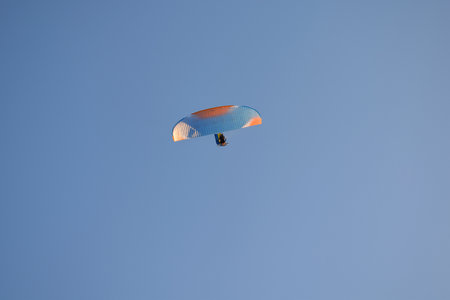 Paraglider flight against the background of a cloudless sky. View from below.の写真素材