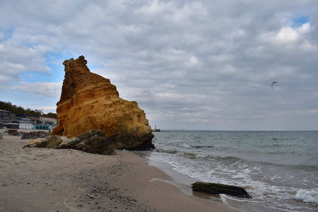 A large yellow stone on a sandy beach in Odessa (Ukraine)の写真素材
