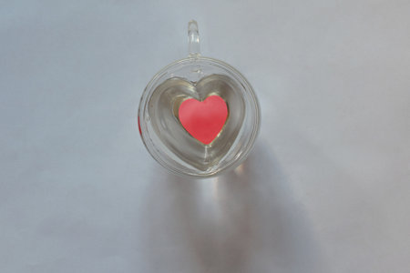 A glass mug with a heart-shaped bottom as a Valentine's Day gift.の写真素材