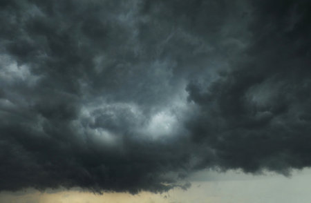 The sky is completely covered with heavy black storm clouds.