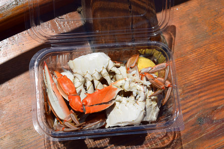 Boiled sea crab in a transparent plastic container.の写真素材