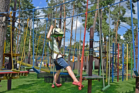 A boy concentrates on completing an obstacle course in a park.の写真素材