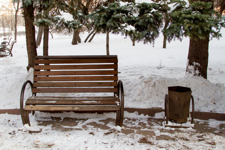 bench with an urn in a park in winterの写真素材