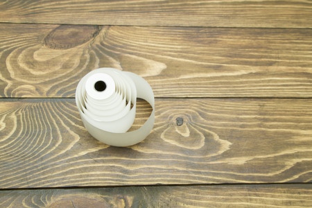 a roll of white paper on the table from an old treeの写真素材