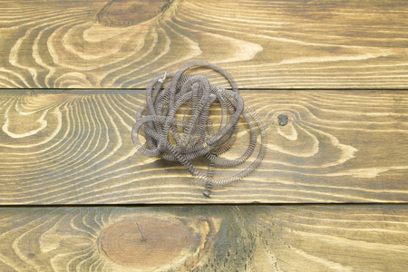 coil of wire on the table of the old boardsの写真素材