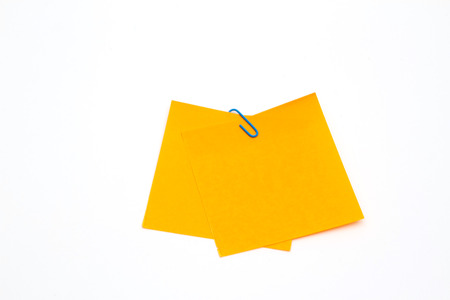 note with a paper clip on a white backgroundの写真素材