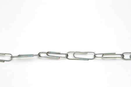 stationery multicolored paper clips on a white backgroundの写真素材