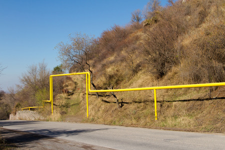 mountain road on private land next to the passing of the gas pipeの写真素材
