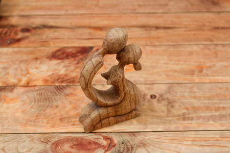 wooden figurine of a pair on the tableの写真素材
