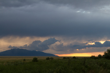 steppes with mountains at sunset before the stormの写真素材