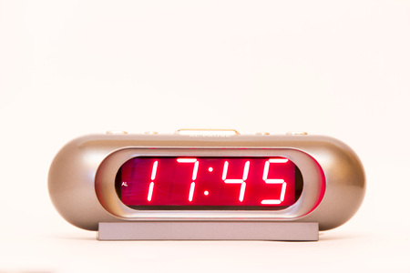 electronic clock alarm clock with red illumination and the time 17:45の写真素材
